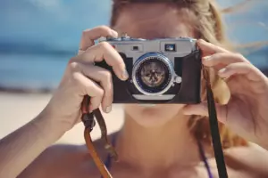 blonde woman holding a camera