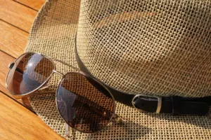 Hat and sunglasses on a dock