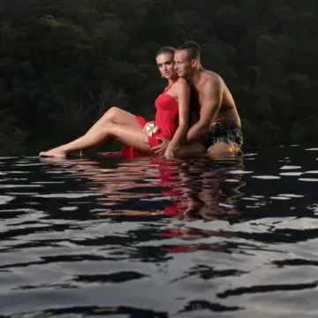 Tropical adult couple sitting in the water